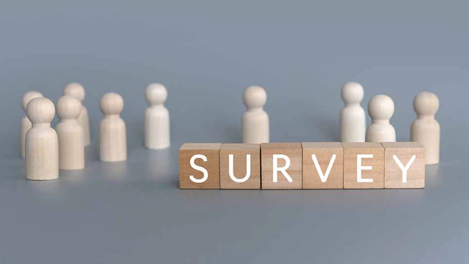 GPT Wooden figures standing beside blocks spelling "SURVEY" on a blue background.
