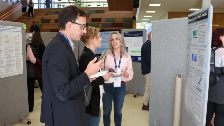 Conference participants discussing research posters at the Nordic-Baltic PIAAC Conference.