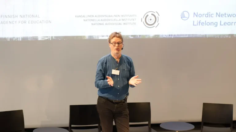 A speaker presenting at a Nordic lifelong learning event.